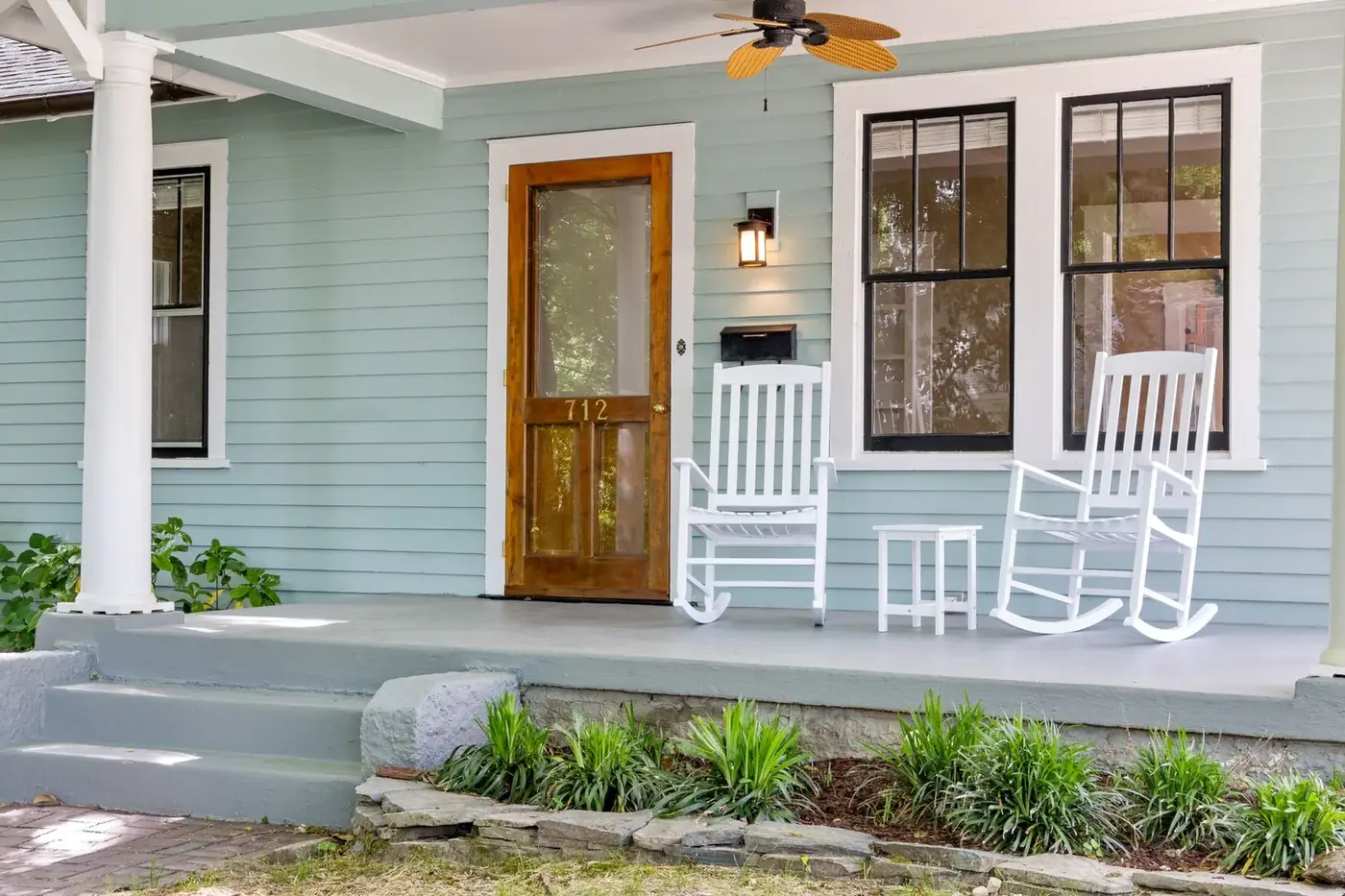 Painted concrete front porch and steps with white rocking chairs